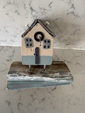 Cottage on stilts on the beach on a chunk of driftwood. Handmade. . Wood.