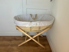 Moses basket with a stand.