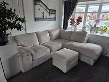 Cream corded corner sofa with pouffe.Great condition.Width 250cm X length 220cm.