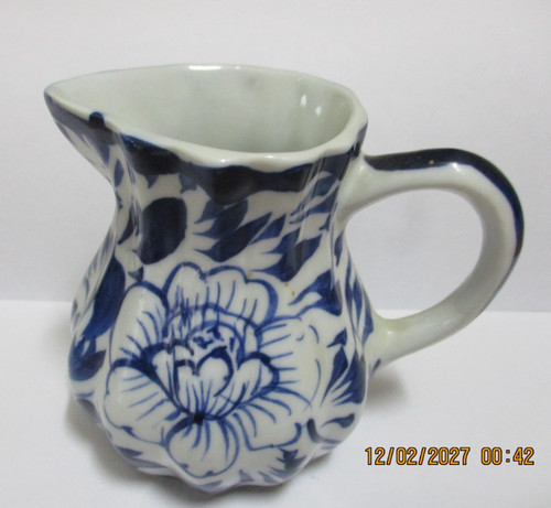 Small blue and white milk - white, jug