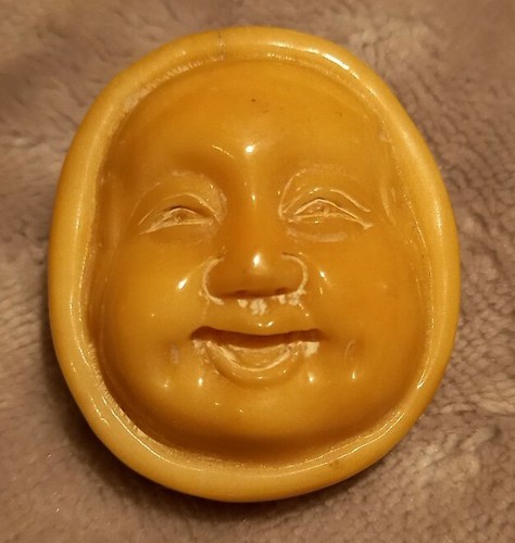 Signed carved oriental face - &,